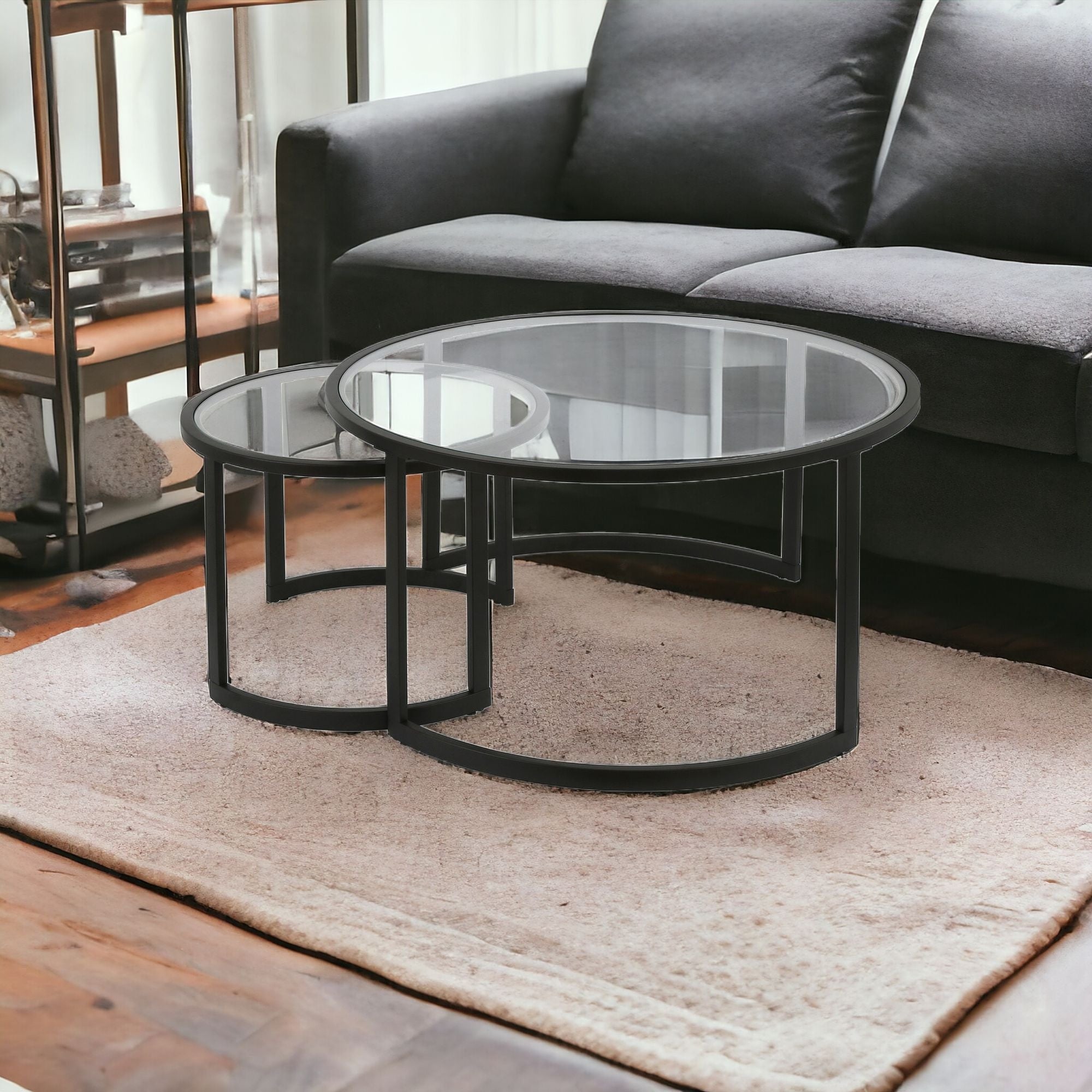 Set of Two 36" Black Glass And Steel Round Nested Coffee Tables